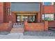 Inviting brick condo entrance with prominent signage and a glimpse of the interior lobby at 534 E 7Th Ave # 107, Denver, CO 80203