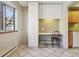 Bright dining area with built-in storage and a desk, perfect for a home office at 534 E 7Th Ave # 107, Denver, CO 80203