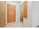 Tiled entryway with wooden door and storage with access to another room at 534 E 7Th Ave # 107, Denver, CO 80203