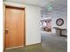 Condo hallway with neutral carpet, light walls, and door number 107 at 534 E 7Th Ave # 107, Denver, CO 80203