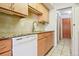 Bright kitchen with stainless steel appliances, light wood cabinets, and tile backsplash at 534 E 7Th Ave # 107, Denver, CO 80203