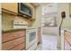Bright kitchen featuring granite countertops, modern appliances, and stylish backsplash at 534 E 7Th Ave # 107, Denver, CO 80203
