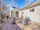 Inviting backyard patio area featuring stone flooring, comfortable seating, and a stylish heater at 5920 S Bemis St, Littleton, CO 80120