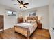 Cozy bedroom with hardwood floors, natural light, and rustic wood furniture at 5920 S Bemis St, Littleton, CO 80120