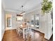 Light-filled dining room with hardwood floors, white trim, and French doors to the patio at 5920 S Bemis St, Littleton, CO 80120