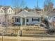 Charming single-story home with gray siding, a well-manicured front yard, and a black wrought iron fence at 5920 S Bemis St, Littleton, CO 80120