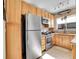 Well-equipped kitchen with stainless steel appliances, wood cabinets, and tile backsplash at 5920 S Bemis St, Littleton, CO 80120