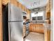 Updated kitchen featuring stainless steel appliances, natural wood cabinets, and modern fixtures at 5920 S Bemis St, Littleton, CO 80120