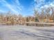 A neighborhood pond is partially frozen with homes visible in the background on a bright sunny day at 5920 S Bemis St, Littleton, CO 80120