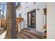 Charming backyard entrance with wooden steps leading to a white brick home at 1922 E 18Th Ave, Denver, CO 80206