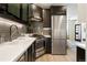 Modern kitchen featuring stainless steel appliances and dark cabinetry at 1922 E 18Th Ave, Denver, CO 80206