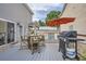 Backyard deck with a charming barrel table, chairs, grill, and a bright red umbrella at 11832 Zenobia Loop, Westminster, CO 80031