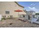 Backyard setting features a small deck, umbrella, seating, and low-maintenance rock landscaping at 11832 Zenobia Loop, Westminster, CO 80031