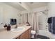 Standard bathroom features a full shower and bathtub with a single sink and light wood cabinetry at 11832 Zenobia Loop, Westminster, CO 80031
