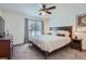Comfortable bedroom with ceiling fan, a large window and a warm wooden bed frame at 11832 Zenobia Loop, Westminster, CO 80031