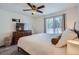 Comfortable bedroom with ceiling fan, a large window and a flat-screen TV at 11832 Zenobia Loop, Westminster, CO 80031