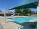 Community pool area, featuring a large swimming pool, lounge chairs, and covered seating at 11832 Zenobia Loop, Westminster, CO 80031