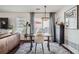 Bright dining area with hardwood floors, a modern light fixture, and views to the outdoor patio at 11832 Zenobia Loop, Westminster, CO 80031