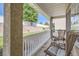 Inviting front porch featuring comfortable wicker chairs and a small glass-topped table at 11832 Zenobia Loop, Westminster, CO 80031