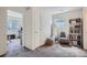 Hallway with carpeted floor, a full length mirror, chair, bookshelf and window at 11832 Zenobia Loop, Westminster, CO 80031