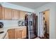 Functional kitchen with light wood cabinets and stainless steel appliances, with easy access to the laundry area at 11832 Zenobia Loop, Westminster, CO 80031