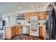 Practical kitchen with light wood cabinets, stainless steel appliances, and efficient layout at 11832 Zenobia Loop, Westminster, CO 80031