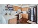Functional kitchen with light wood cabinets, stainless steel appliances, and a view to the adjacent room at 11832 Zenobia Loop, Westminster, CO 80031