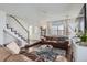 Cozy living room featuring a staircase, hardwood floors, and bright, natural light at 11832 Zenobia Loop, Westminster, CO 80031