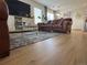 Bright living room featuring wood flooring and a comfortable sofa set at 11832 Zenobia Loop, Westminster, CO 80031