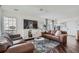 Spacious living room with hardwood floors, comfortable seating, and large windows with natural light at 11832 Zenobia Loop, Westminster, CO 80031