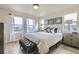 Bright bedroom boasts a large bed, modern furnishings, and plenty of natural light from multiple windows at 128 E Douglas St, Superior, CO 80027