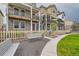 A row of charming townhomes featuring cozy patios, a welcoming walkway, and manicured lawns at 128 E Douglas St, Superior, CO 80027