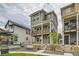 Charming three-story home featuring a welcoming porch and well-maintained yard with a cozy seating area and fence at 128 E Douglas St, Superior, CO 80027