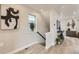 Bright hallway with stairs, modern art, and stylish decor at 128 E Douglas St, Superior, CO 80027