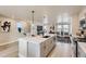 Open-concept kitchen flows into the living area, featuring a large island, stainless appliances, and modern finishes at 128 E Douglas St, Superior, CO 80027
