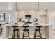 Stylish kitchen island with seating, modern fixtures, stainless appliances, and an open floorplan with great natural light at 128 E Douglas St, Superior, CO 80027