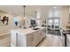 Modern kitchen with a spacious center island, stainless steel appliances, and open to the living area at 128 E Douglas St, Superior, CO 80027