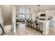 Open kitchen boasts a large island with seating, stainless appliances, and modern finishes overlooking living area at 128 E Douglas St, Superior, CO 80027