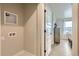 Bright laundry area features hookups and leads to a hallway with wood floors and neutral paint at 128 E Douglas St, Superior, CO 80027