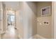 Bright laundry area features hookups and leads to a hallway with wood floors and neutral paint at 128 E Douglas St, Superior, CO 80027