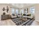 Bright living room featuring neutral furniture, modern art, and large windows at 128 E Douglas St, Superior, CO 80027