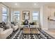 Cozy living room with neutral color palette, stylish rug, ample natural light, and contemporary furnishings at 128 E Douglas St, Superior, CO 80027