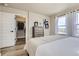 Bright main bedroom features a closet, dresser, and many windows for natural light at 128 E Douglas St, Superior, CO 80027