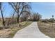 Scenic walking path through a neighborhood is lined with trees, providing a tranquil escape at 128 E Douglas St, Superior, CO 80027