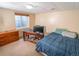 Basement bedroom featuring a desk, dresser and window at 6118 Salvia Ct, Arvada, CO 80403