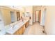 Large bathroom features a double vanity, tile flooring, and a large mirror with great lighting at 6118 Salvia Ct, Arvada, CO 80403