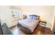Cozy bedroom features wood floors, a comfortable bed, and a bright window for natural light at 6118 Salvia Ct, Arvada, CO 80403