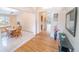 Inviting foyer with hardwood floors leading to a dining area with a wooden table and chairs at 6118 Salvia Ct, Arvada, CO 80403