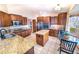 Spacious kitchen features granite countertops, stainless steel appliances, a center island, and a cozy breakfast nook at 6118 Salvia Ct, Arvada, CO 80403