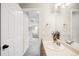 A clean bathroom featuring a vanity with a sink and a view into the upstairs hallway at 9481 Longstone Dr, Parker, CO 80134